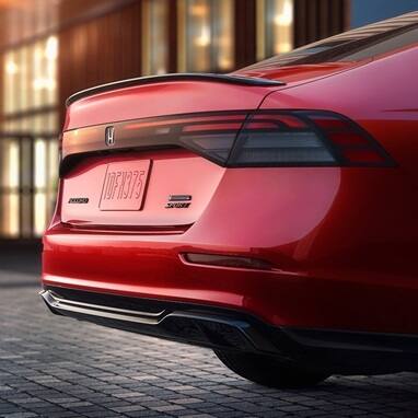 Rear shot of 2026 Honda Accord in Radiant Red Metallic showing Rear Spoiler and Rear Diffuser detail.